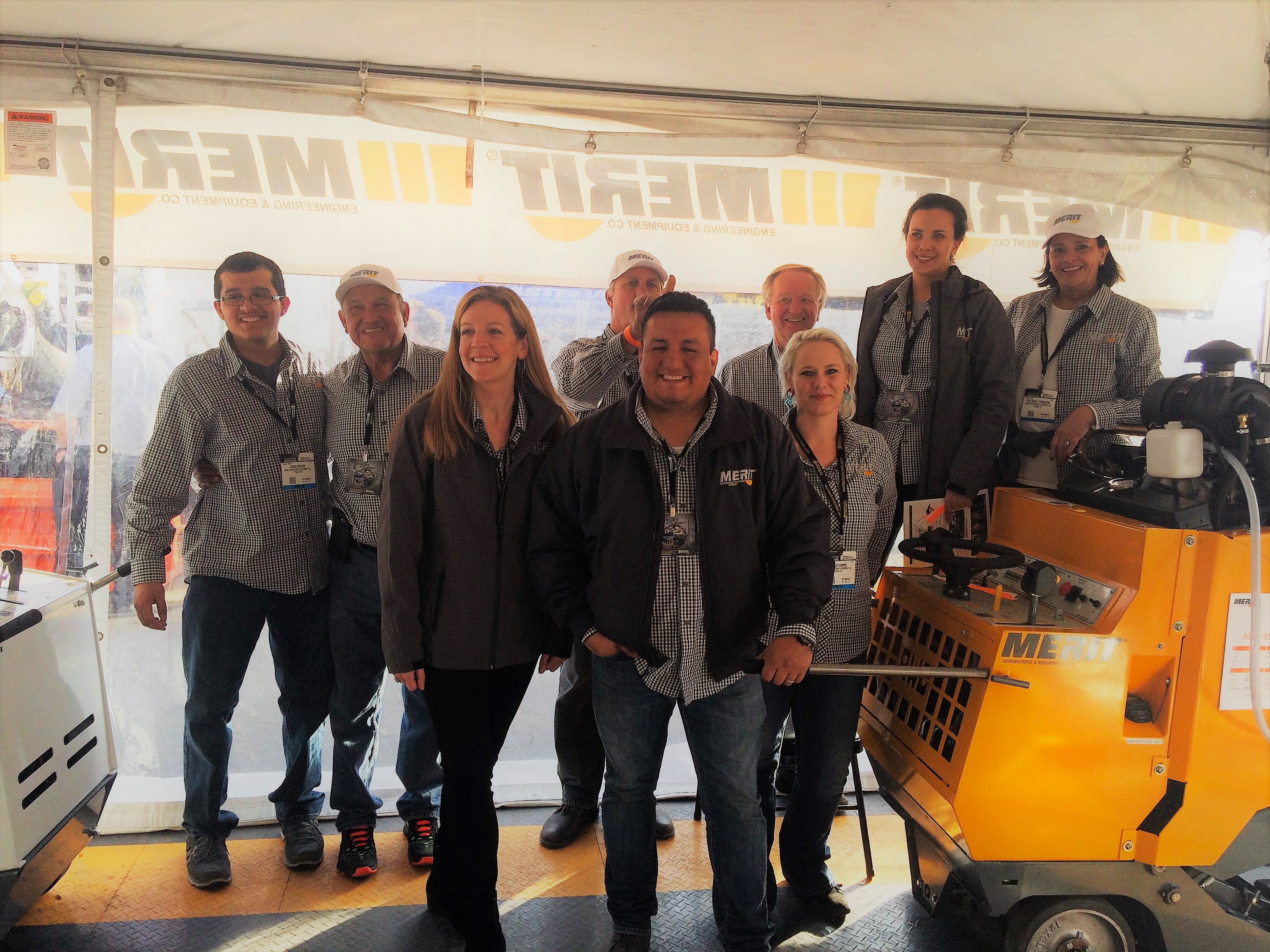 Merit Saw staff and distributors pose at Merit's outdoor booth at the 2017 World of Concrete Show.