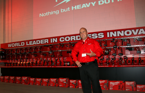 Milwaukee's Paul Fry speaks with trade press in front of the company's wall-o-cordless tools.  ,