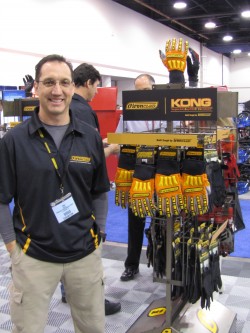 Eric Jaeger, VP of research and development for Ironclad Performance Wear, poses at the National Hardware Show with a display of his company's KONG glove, which has won a special award from the US Department of the Interior's Minerals Management Service (MMS) for exceptional performance in enhancing worker safety. Jaeger worked with the MMS for more than 18 months to design and develop the KONG work glove specifically for the oil & gas industry.