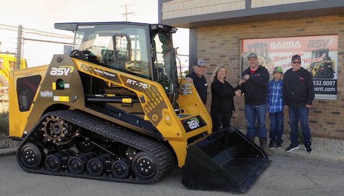 Winner of the ASV MAX-Series sweepstakes, Andrew Stewart, receives a new MAX-Series RT-75 Posi-Track loader for which he won a 1-year lease.