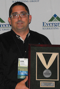 Kirk Burzynski of Jim & Slim's Tool Supply, Largo, FL accepts the Evergreen Marketing Group's Tier 3 Distributor of the Year award.