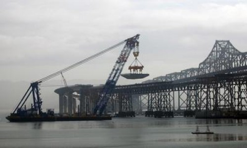 The first permanent section of the Bay Bridge's Self-Anchored Suspension Span is lifted to a temporary support before being moved into place closer to Yerba Buena Island in San Francisco, Calif. on Wednesday, Feb. 3, 2010. (Dean Coppola/Staff) ( Dean Coppola )